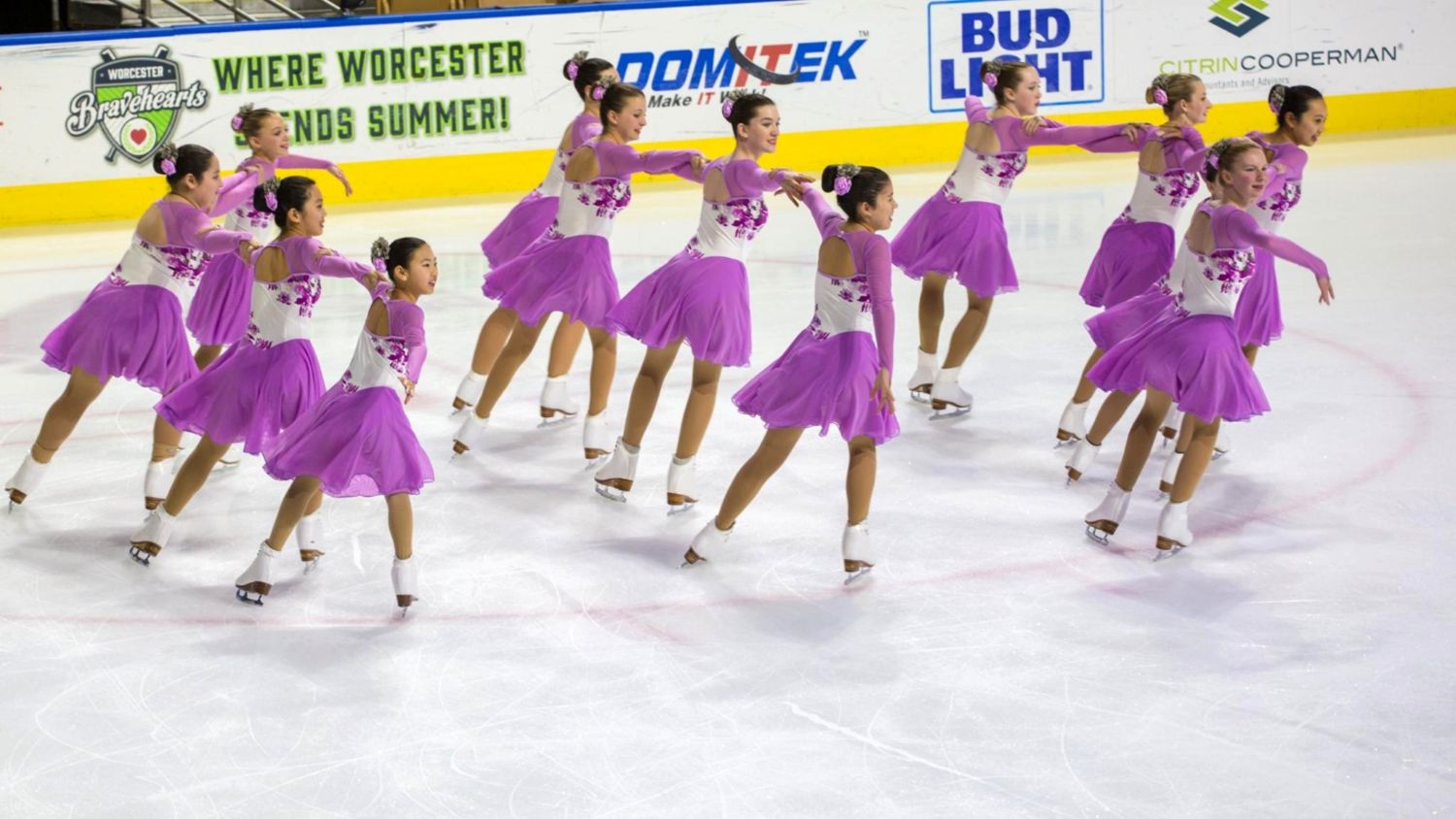Richmond va aspire 4 skating team in purple costumes mid-routine at a competition